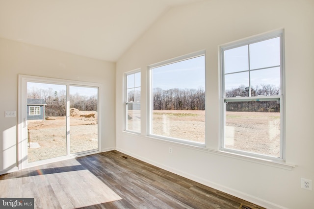 unfurnished sunroom featuring vaulted ceiling