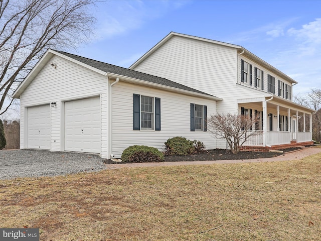 view of home's exterior featuring a garage, driveway, a porch, and a lawn