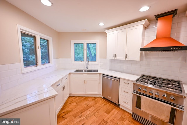 622 Hastings Rd, Baltimore, MD 21286 - kitchen with stainless steel appliances, wall chimney range hood, healthy amount of natural light, light stone counters, and recessed lighting