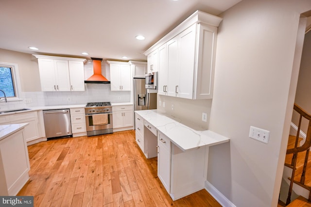 622 Hastings Rd, Baltimore, MD 21286 - kitchen with stainless steel appliances, premium range hood, light wood-style flooring, white cabinets, and recessed lighting