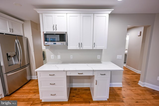 622 Hastings Rd, Baltimore, MD 21286 - kitchen with stainless steel appliances, white cabinets, built in desk, and light wood-type flooring