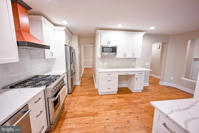 622 Hastings Rd, Baltimore, MD 21286 - kitchen with appliances with stainless steel finishes, wall chimney exhaust hood, white cabinetry, light wood-type flooring, and recessed lighting
