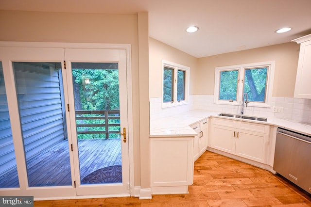 622 Hastings Rd, Baltimore, MD 21286 - kitchen featuring stainless steel dishwasher, light wood finished floors, white cabinets, tasteful backsplash, and recessed lighting