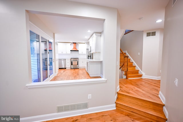 622 Hastings Rd, Baltimore, MD 21286 - hallway featuring light wood-style floors, stairs, and recessed lighting