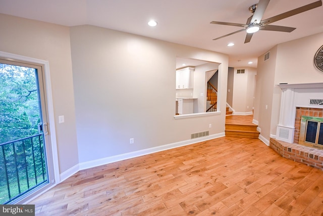 622 Hastings Rd, Baltimore, MD 21286 - unfurnished living room with light wood-style floors, a fireplace, ceiling fan, stairway, and recessed lighting