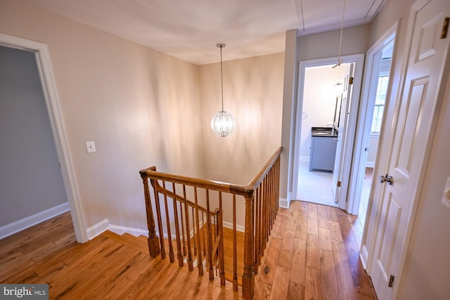 622 Hastings Rd, Baltimore, MD 21286 - corridor with an upstairs landing, light wood-style floors, attic access, and a chandelier
