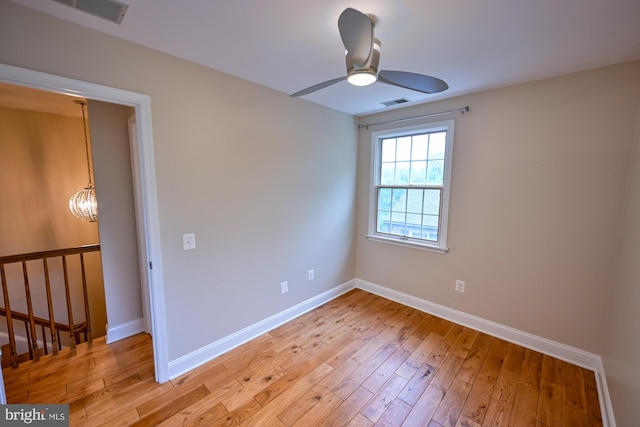 622 Hastings Rd, Baltimore, MD 21286 - empty room with ceiling fan, light wood-style flooring, and a chandelier