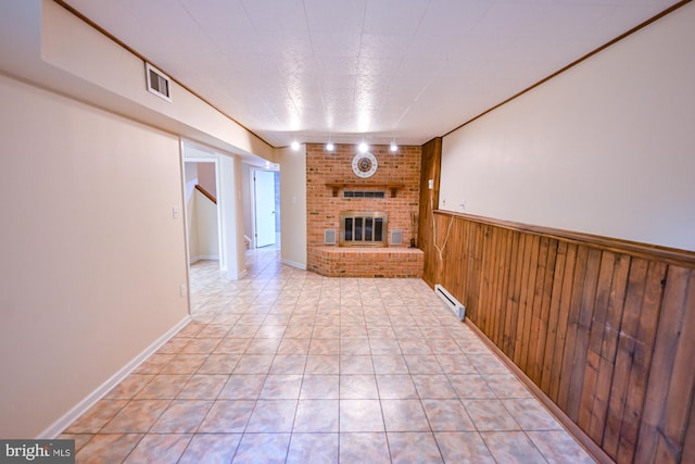 622 Hastings Rd, Baltimore, MD 21286 - unfurnished living room with a baseboard radiator, a fireplace, wooden walls, a wainscoted wall, and stairs