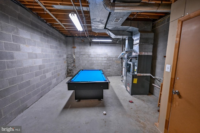 622 Hastings Rd, Baltimore, MD 21286 - unfinished below grade area featuring heating unit, billiards table, and concrete block wall