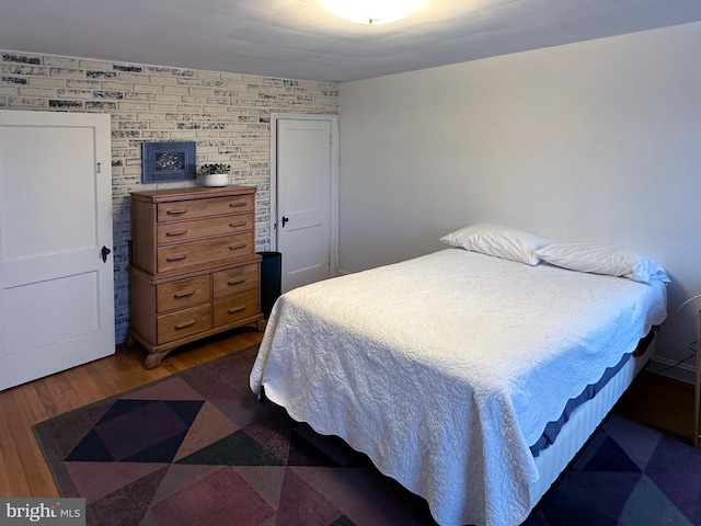 bedroom with dark wood-type flooring