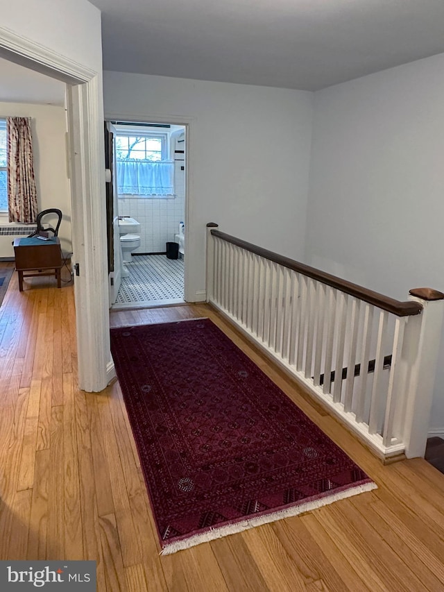 hall with radiator and wood-type flooring