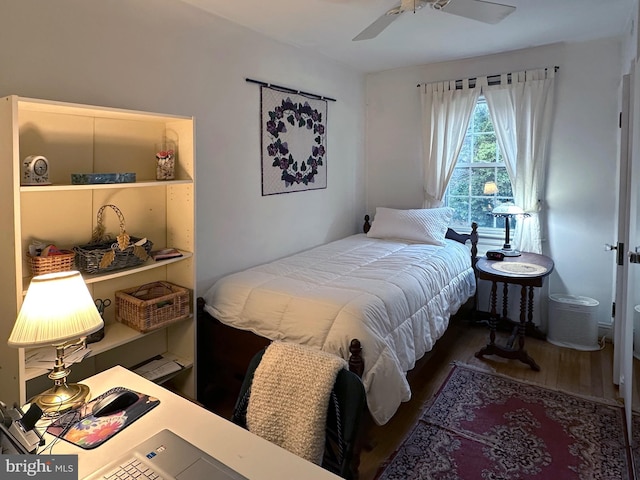 bedroom with a ceiling fan and wood finished floors