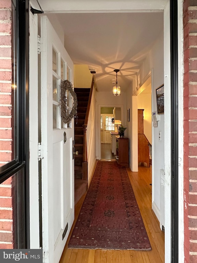 hall with stairway and wood finished floors