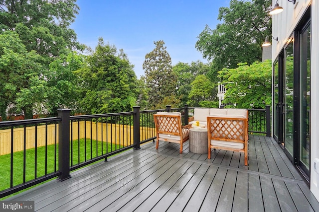 deck featuring a yard and outdoor lounge area