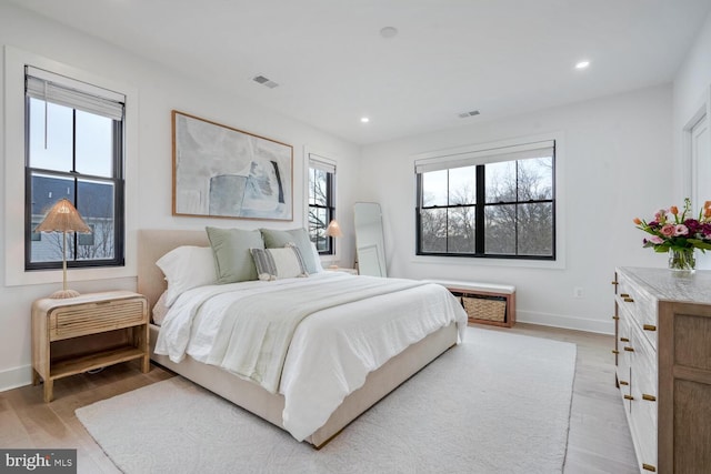 bedroom featuring light wood finished floors, visible vents, and recessed lighting