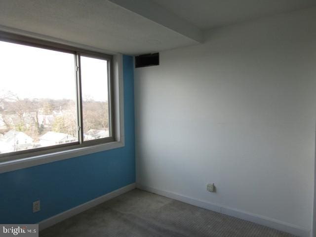 unfurnished room featuring baseboards and carpet flooring