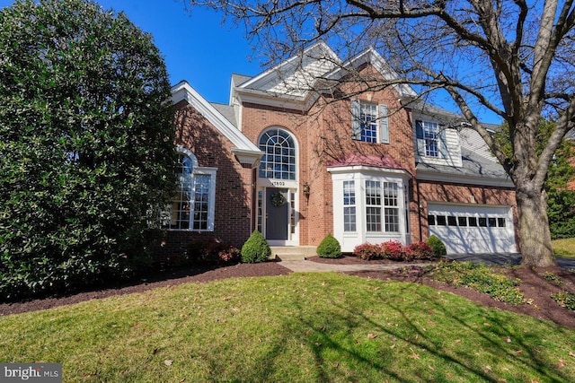 traditional-style home with aphalt driveway, brick siding, a garage, and a front lawn