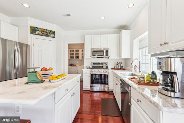 kitchen featuring visible vents, white cabinets, appliances with stainless steel finishes, and a sink