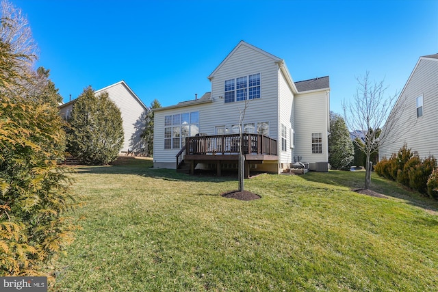 rear view of house featuring cooling unit, a lawn, and a deck