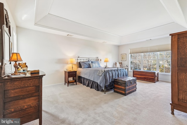 bedroom with baseboards, a raised ceiling, carpet floors, and visible vents