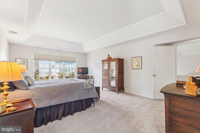 bedroom with visible vents, carpet flooring, a raised ceiling, and baseboards