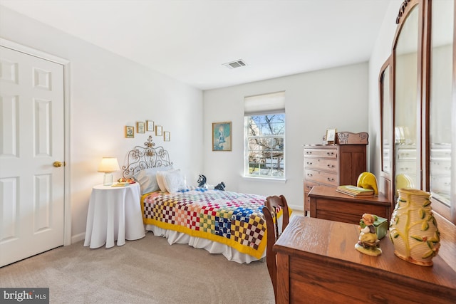 bedroom with visible vents, baseboards, and carpet flooring