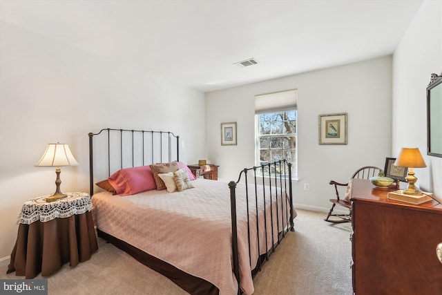 bedroom with visible vents, light colored carpet, and baseboards