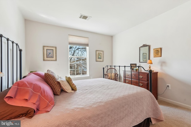 carpeted bedroom with baseboards and visible vents