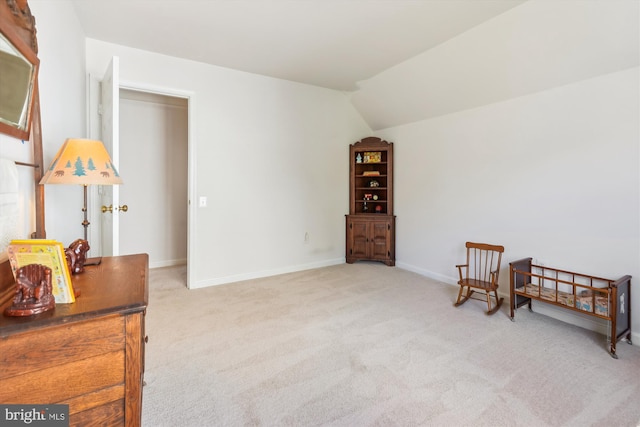 living area with baseboards, lofted ceiling, and carpet flooring