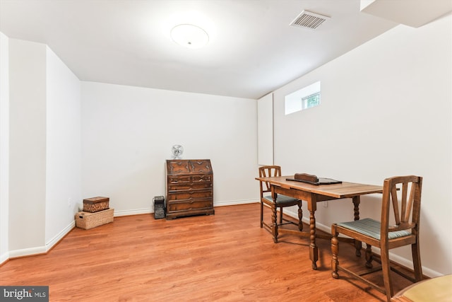 office featuring visible vents, baseboards, and wood finished floors