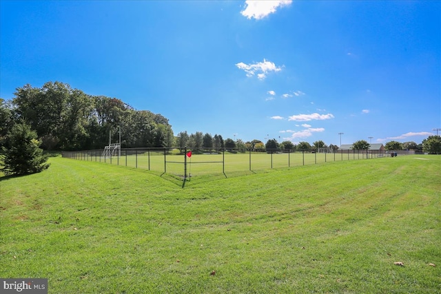 view of yard with a rural view and fence