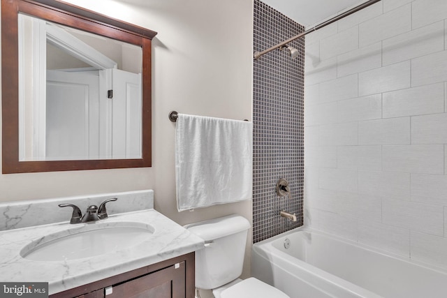 full bathroom with  shower combination, vanity, and toilet