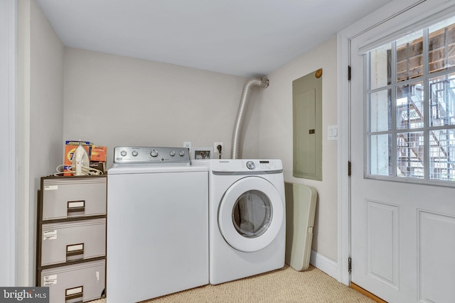 clothes washing area with laundry area, electric panel, and washer and clothes dryer