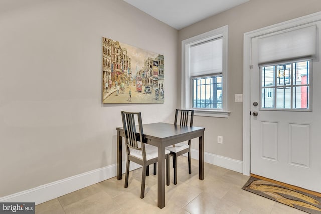 dining room featuring light tile patterned floors and baseboards