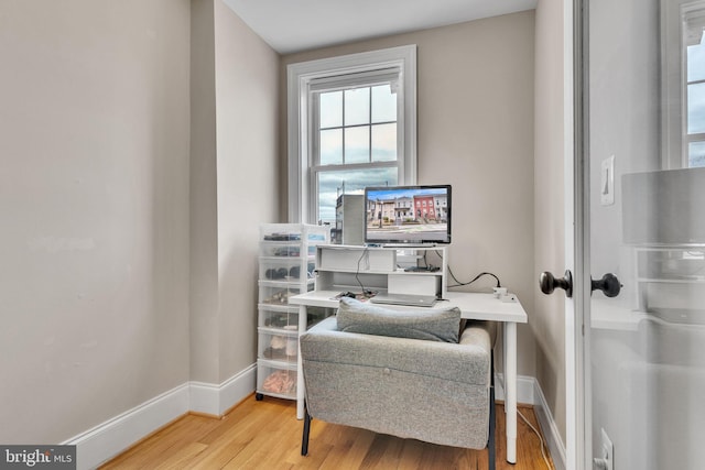 home office with wood finished floors and baseboards