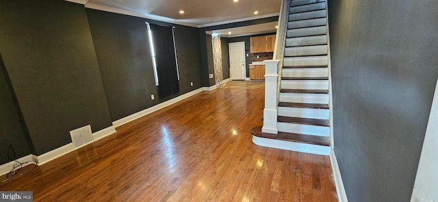 interior space featuring recessed lighting, wood finished floors, visible vents, baseboards, and ornamental molding