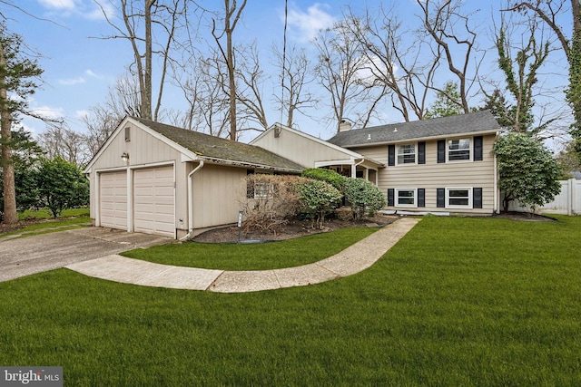 tri-level home with aphalt driveway, an attached garage, fence, a front lawn, and a chimney