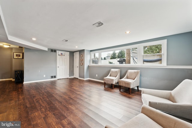 sitting room featuring wood finished floors, visible vents, and baseboards