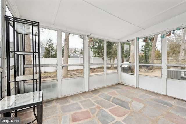 unfurnished sunroom featuring a wealth of natural light and lofted ceiling