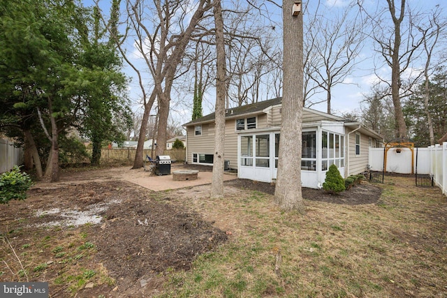 back of house with a patio area, a sunroom, and a fenced backyard