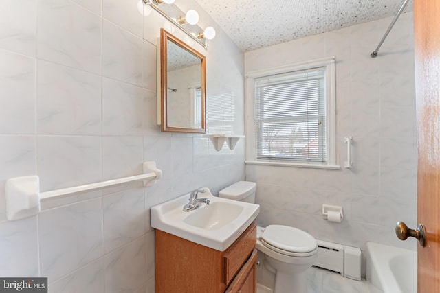 bathroom featuring a baseboard heating unit, tile walls, toilet, and vanity