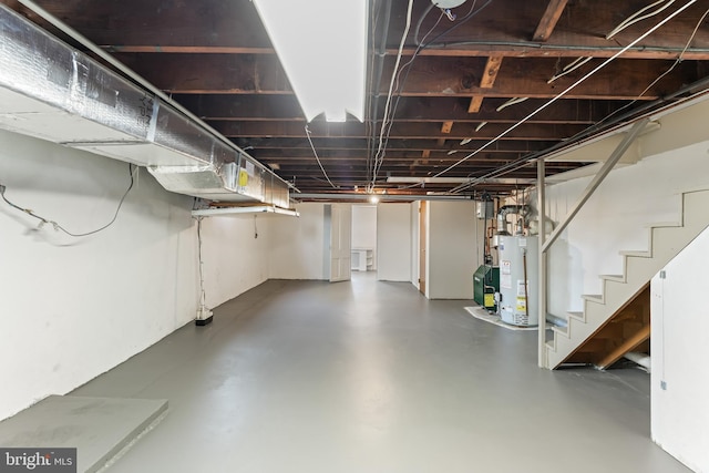 unfinished below grade area with gas water heater and stairway