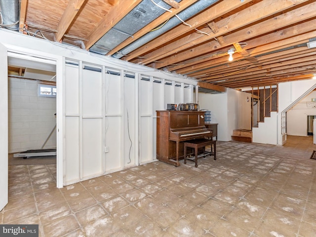 basement with stairs and tile patterned floors