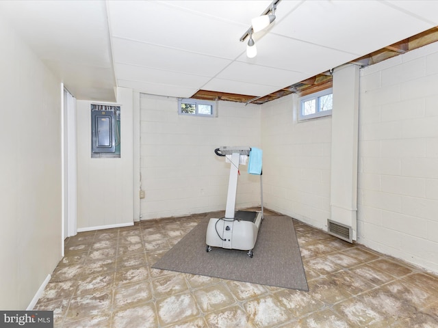 workout area featuring a wealth of natural light, visible vents, and tile patterned floors