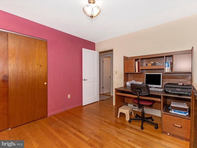 office space featuring baseboards and wood finished floors