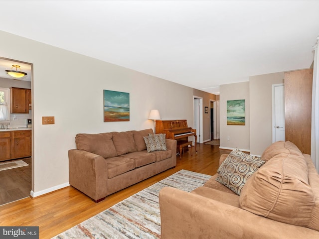 living room featuring light wood-type flooring and baseboards