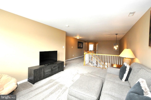 carpeted living area with visible vents and baseboards