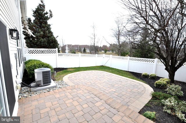 view of patio featuring central AC and a fenced backyard