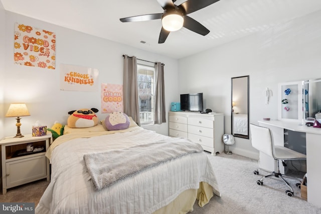 carpeted bedroom with baseboards, visible vents, and a ceiling fan