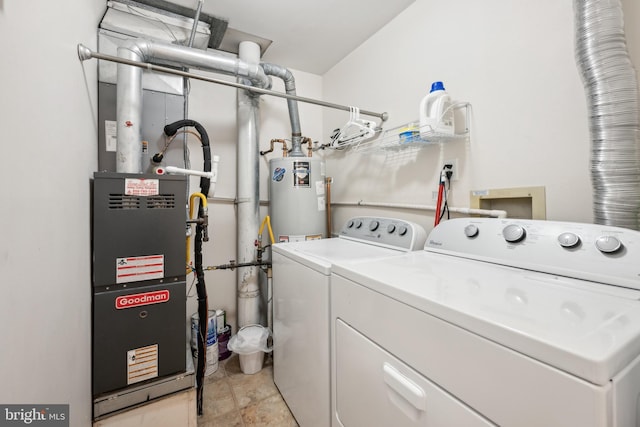 clothes washing area with laundry area, washing machine and dryer, and gas water heater